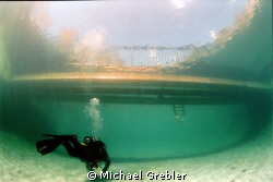 On a bright Sunday afternoon, a diver approaches the floa... by Michael Grebler 